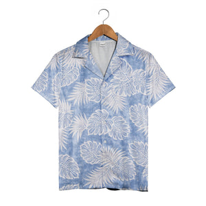 Textured blue Hawaiian shirt with monstera leaves and palm fronds in white outline art