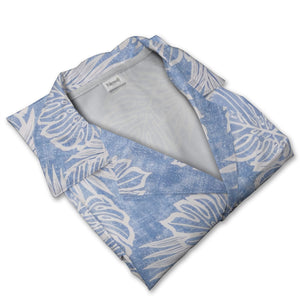Textured blue Hawaiian shirt with monstera leaves and palm fronds in white outline art