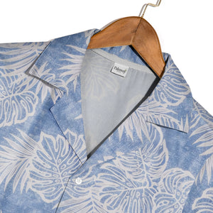 Textured blue Hawaiian shirt with monstera leaves and palm fronds in white outline art